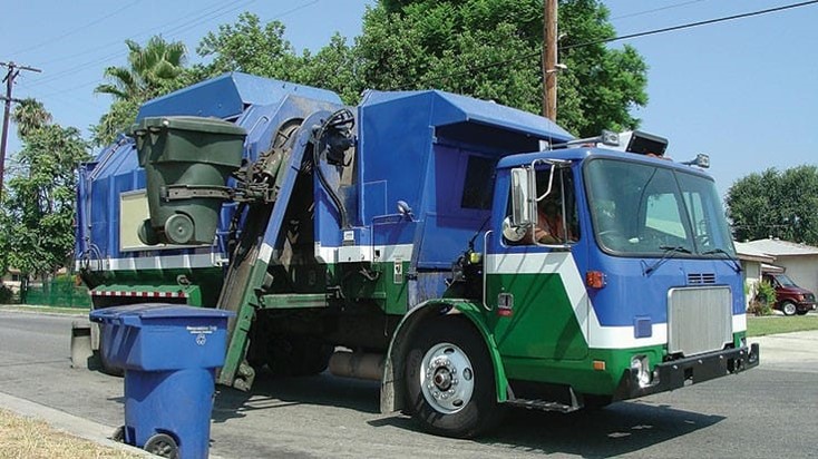 Photo of a modern, blue recycling collection truck.